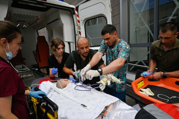 Rocket attack by the Russian army in Kyiv, Ukraine - 08 Jul 2024 Medical workers escort a child and equipment to an emergency vehicle during the evacuation of the children�s hospital Okhmadit during a ...
