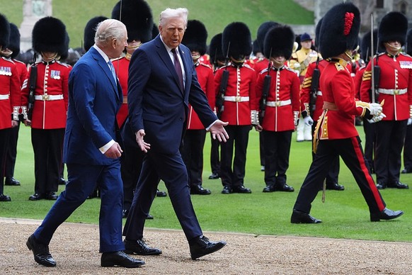 WINDSOR, ENGLAND - SEPTEMBER 17: King Charles III and US President Donald Trump review the guard of honour during the ceremonial welcome during the State visit by the President of the United States of ...