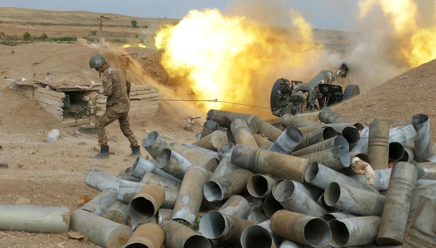 In this Sunday, Oct. 4, 2020 photo, an Armenian soldier fires an artillery piece during fighting with Azerbaijan&#039;s forces in self-proclaimed Republic of Nagorno-Karabakh, Azerbaijan. Sunday, Oct. ...