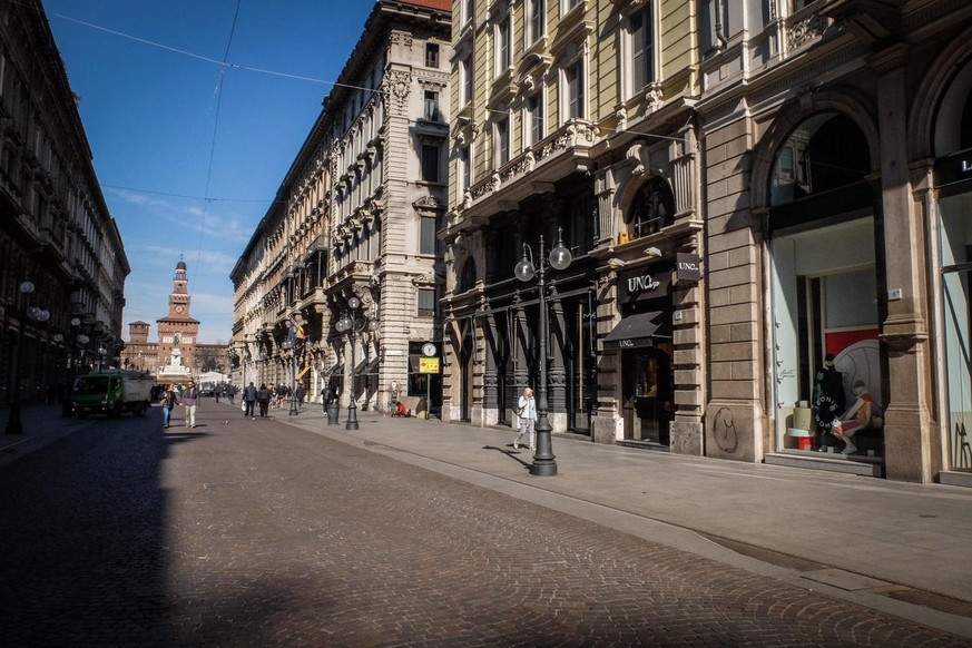 epa08278004 A view of a nearly-empty street in the downtown area of the Lombardian capital of Milan, northern Italy, 08 March 2020. The Italian authorities have taken the drastic measure of shutting o ...