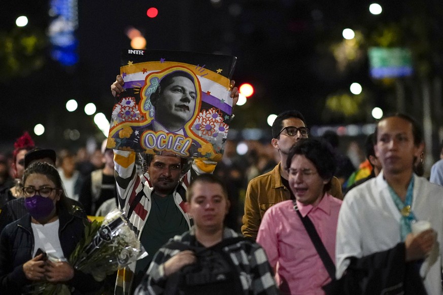 Demonstrators march with a picture of Aguascalientes state electoral court magistrate Jesus Ociel Baena in Mexico City, Monday, Nov. 13, 2023. The first openly nonbinary person to assume a judicial po ...