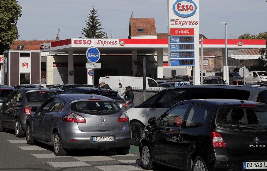 Drivers line up as they wait to buy gas in a station, in Lille, northern France, Friday, Oct. 7, 2022. Shortages which the government says are largely caused by strikes that have hit French fuel refin ...