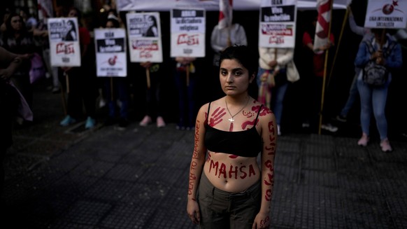 Women protests against the death of Mahsa Amini, a woman who died while in police custody in Iran, in front of the Iranian embassy in Buenos Aires, Argentina, Tuesday, Sept. 27, 2022. Mahsa Amini was  ...