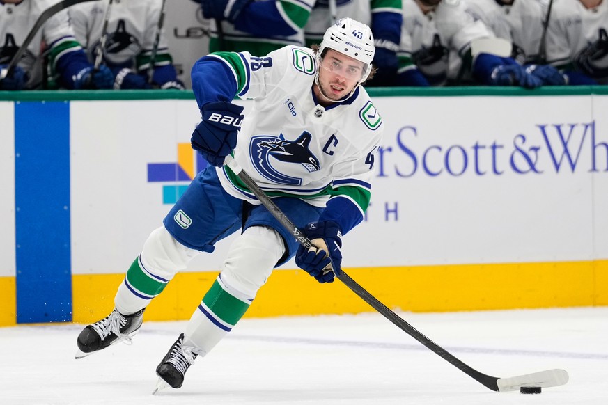 FILE - Vancouver Canucks defenseman Quinn Hughes makes a pass during an NHL hockey game against the Dallas Stars Thursday, Oct. 16, 2025, in Dallas. (AP Photo/Tony Gutierrez, File)
Quinn Hughes