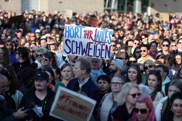 BERLIN, GERMANY - MARCH 22: Women hold up placards as they take part in a demonstration in support of Actress Collien Fernandes who called for against sexual, psychological and physical violence direc ...