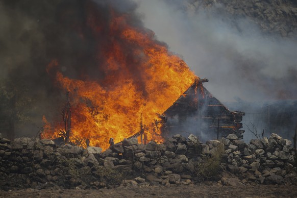 A fire engulfs a house in Cokertme village, near Bodrum, Mugla, Turkey, Tuesday, Aug. 3, 2021. As Turkish fire crews pressed ahead Tuesday with their weeklong battle against blazes tearing through for ...