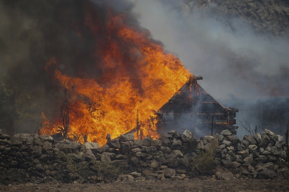 A fire engulfs a house in Cokertme village, near Bodrum, Mugla, Turkey, Tuesday, Aug. 3, 2021. As Turkish fire crews pressed ahead Tuesday with their weeklong battle against blazes tearing through for ...