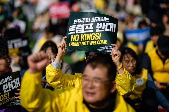 Protesters shout slogans and hold placards during a rally against US President Donald Trump and the Asia-Pacific Economic Cooperation (APEC) Summit in Gyeongju on November 1, 2025. (Photo by ANTHONY W ...