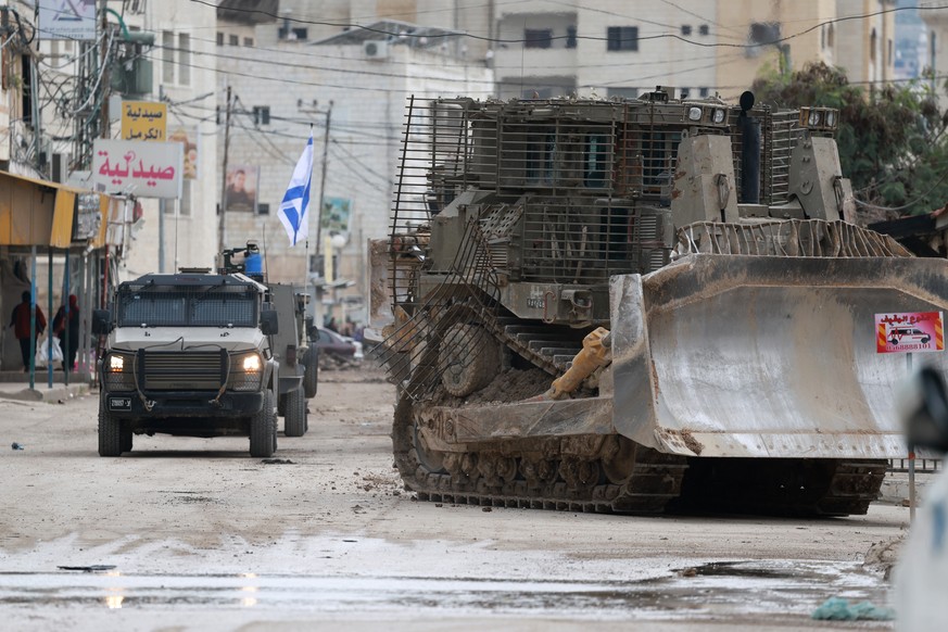 epa11844108 Israeli army vehicles on a road on the second day of an Israeli military operation in the West Bank city of Jenin, 22 January 2025. The Israeli military launched a &#039;counterterrorism o ...