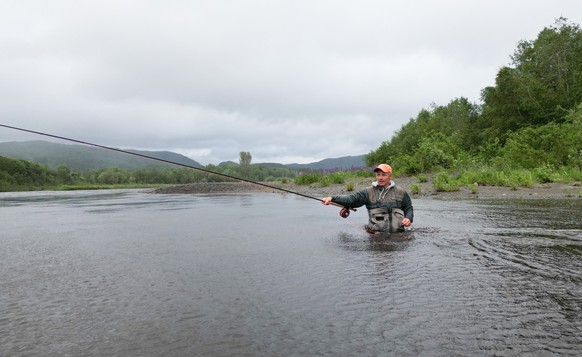 Christer Kristoffersen, a local angler, casts his line in the river in Hegra, Norway, on June 19, 2025. Waist-deep in a rain-swollen river, Christer Kristoffersen casts his line, lands it gently on th ...