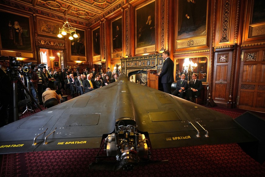 FILE - Foreign Minister of Poland, Radek Sikorski speaks next to an Iranian Shahed-136 attack drone, acquired from Ukraine by United Against Nuclear Iran (UANI), at a press conference in Parliament in ...