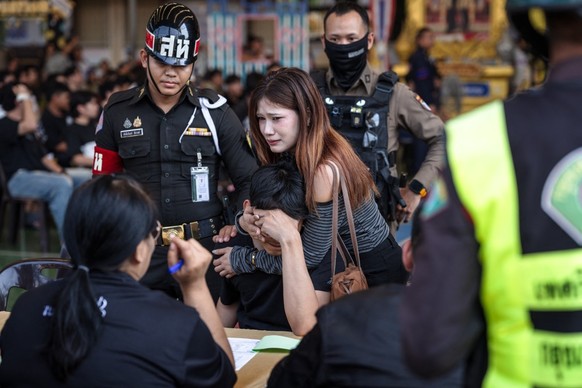 A man reacts after picking a red ballot, meaning mandatory enlistment, during the Thai military conscription drawing at Watmatchantikaram School in Bangkok on April 7, 2026. (Photo by chanakarn LAOSAR ...