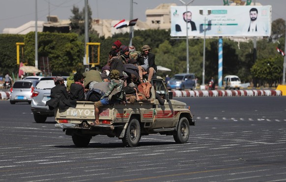 December 12, 2023, SANAA, Sanaa, Yemen: Houthi fighters ride a truck in the street in Sana a, The Iran-backed Houthis in Yemen claimed responsibility for a military operation targeting the Norwegian c ...