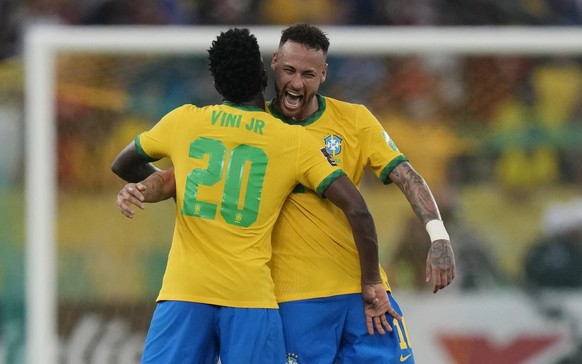 Brazil&#039;s Neymar, right, celebrates with teammate Vini Jr after scoring his side&#039;s opening goal from the penalty spot during a qualifying soccer match for the FIFA World Cup Qatar 2022 agains ...