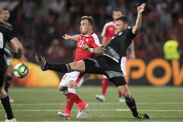 Swiss forward Xherdan Shaqiri, left, fights for the ball with Belarus&#039; Aliaksandr Paulavets, right, during a friendly soccer match on the side line of the 2018 Fifa World Cup group B qualificatio ...