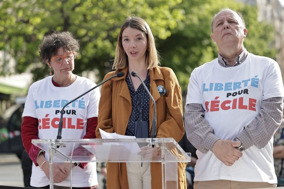 Noemie Kohler (C), her mother Mireille Kohler and her father Pascal Kohler speak during a rally to mark the three-year detention of their sister and daughter Cecile Kohler, and her companion Jacques P ...
