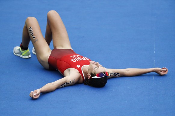Silver medal winner Nicola Spirig of Switzerland is exhausted in the finish during the women&#039;s Triathlon in Fort Copacabana at the Rio 2016 Olympic Summer Games in Rio de Janeiro, Brazil, picture ...