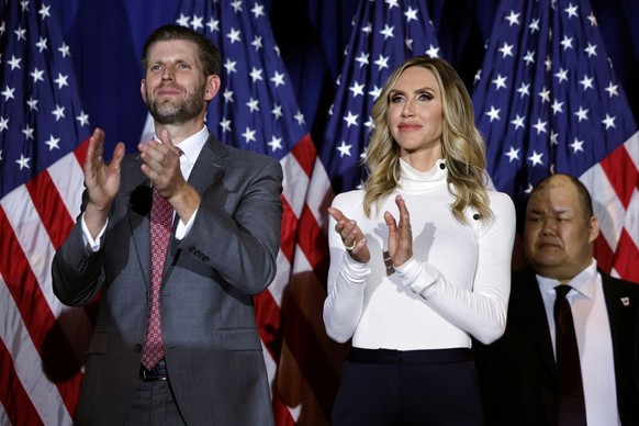 NASHUA, NEW HAMPSHIRE - JANUARY 23: Eric Trump (L) and his wife, Lara Trump, applaud for Republican presidential candidate and former U.S. President Donald Trump, during a primary night party at the S ...