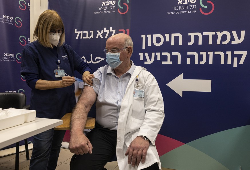 Professor Jacov Lavee receives a fourth dose of Pfizer-BioNTech COVID-19 vaccine, at Sheba Medical Center in Ramat Gan, Israel, Monday, Dec. 27, 2021. Israel began trials of a fourth dose of coronavir ...