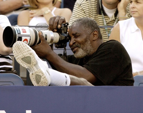 Richard Williams, father of U.S. Open semifinalists Venus and Serena Williams, takes photographs during the semifinal match between Serena and Lindsay Davenport at the U.S. Open tennis tournament in N ...