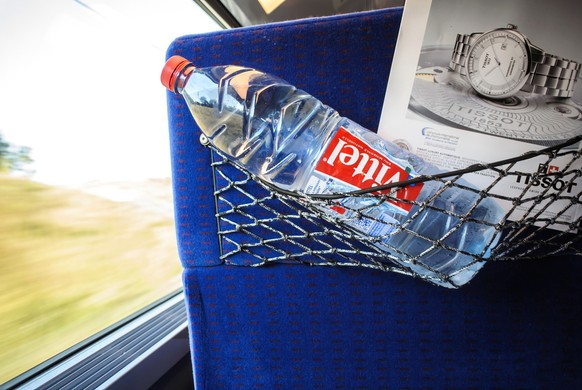 Switzerland - Jul 17, 2014: Interior of a fast motion train with front passeger seat holding Vittel drinking water bottle by Vittel - owned by the Swiss company Nestle xkwx bottle, water bottle, bever ...