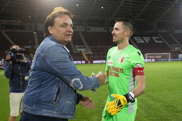 Christian Constantin, left, President of FC Sion, congratules his player goalkeeper Kevin Fickentscher, right, after wining the match and saving their place in the Super League, following the Super Le ...