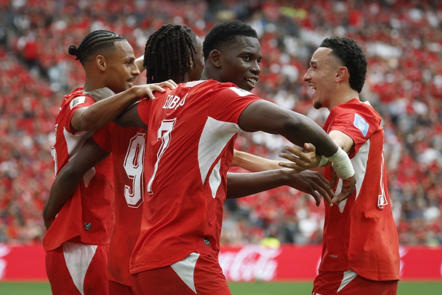 Switzerland's Johan Manzambi, center, celebrates with teammates Breel Embolo, front, Djibril Sow, left, and Ruben Vargas after scoring the second goal during the World Cup Group B soccer match be ...