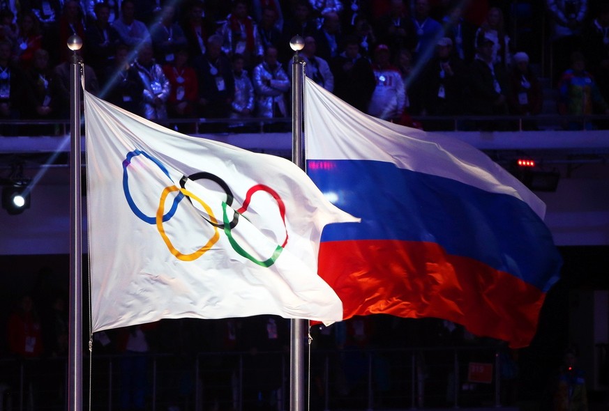 epa08889979 (FILE) - The Olympic flag (L) and the Russian flag (R) fly during the closing ceremony of the Sochi 2014 Olympic Games at Fisht Olympic Stadium in Sochi, Russia, 23 February 2014 (re-issue ...