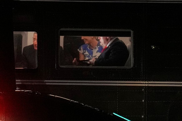 President Donald Trump, from right, is pictured on Air Force One seated with White House aide Natalie Harp and Sen. John Barrasso, R-Wyo., at Joint Base Andrews, Md., Friday, Aug. 21, 2026, after spea ...
