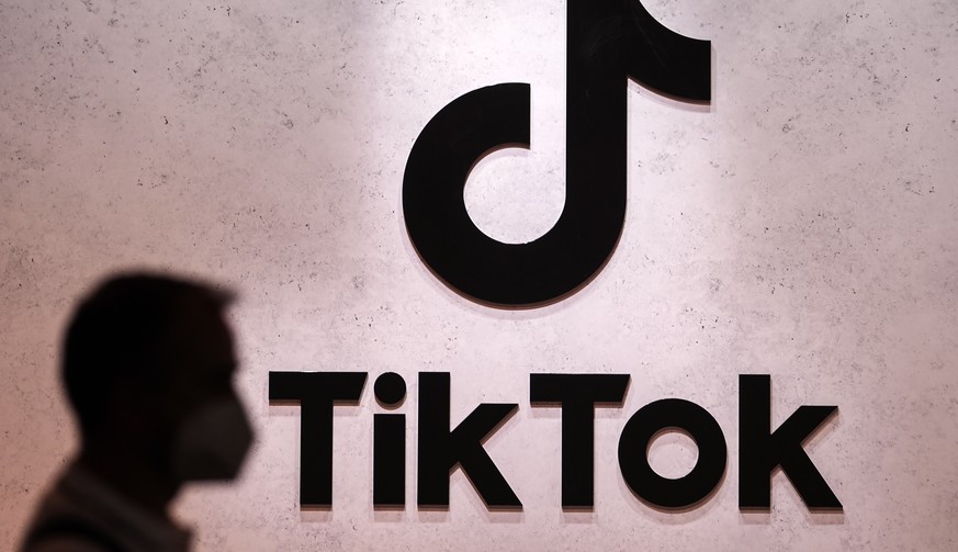 FILE - A visitor passes the TikTok exhibition stands at the Gamescom computer gaming fair in Cologne, Germany, Thursday, Aug. 25, 2022. The European Union&#039;s executive arm said Thursday, Feb. 23,  ...