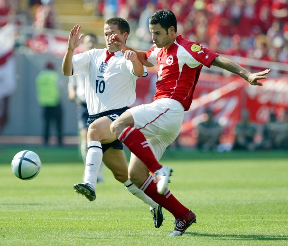 England's Michael Owen, left, and Switzerland's Bernt Haas battle for the ball during their Group B Euro 2004 first round match at the Cidade de Coimbra Stadium, in Coimbra, Portugal, Thursday, June 1 ...