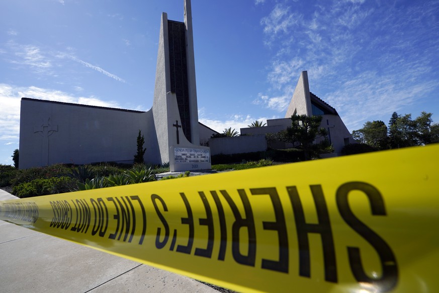 Crime scene tape is stretched across an area at Geneva Presbyterian Church in Laguna Woods, Calif., Sunday, May 15, 2022, after a fatal shooting. (AP Photo/Damian Dovarganes)