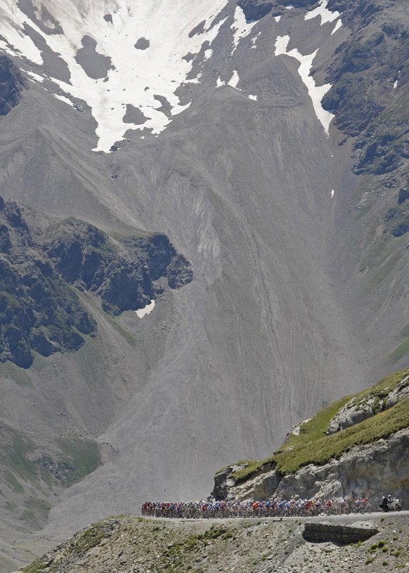 The pack climbs towards Galibier pass during the 17th stage of the Tour de France cycling race between Embrun and l&#039;Alpe-d&#039;Huez, French Alps, Wednesday July 23, 2008. (AP Photo/Christophe En ...