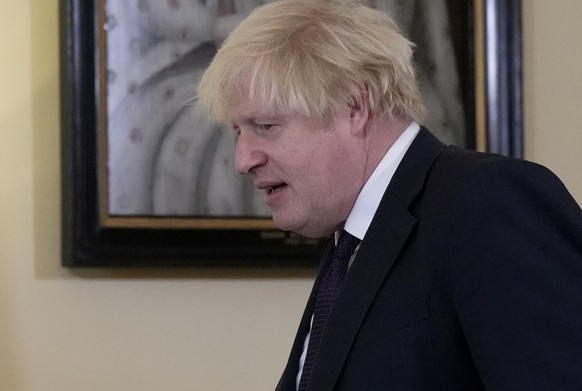 British Prime Minister Boris Johnson walks past a painting of Queen Elizabeth I as he walks in the room with the Sultan of Brunei, Hassanal Bolkiah, at the start of their meeting inside 10 Downing Str ...