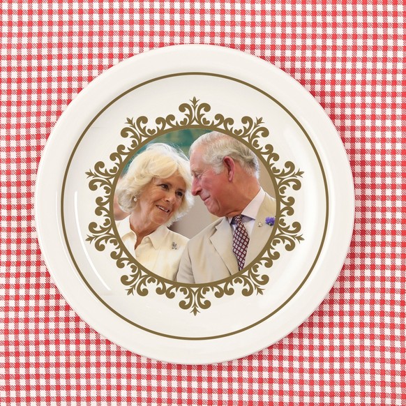 White empty plate on red checked tablecloth