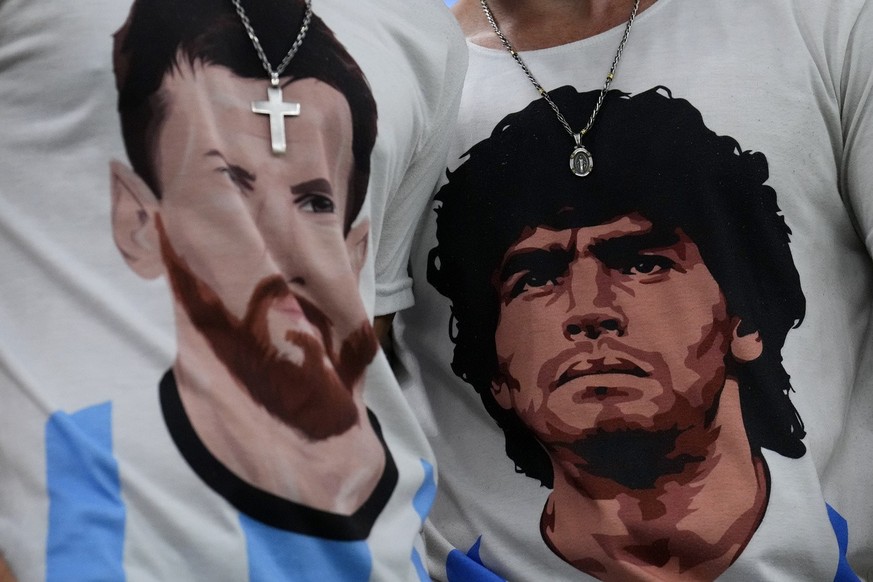 Fans of Argentina wear t-shirts of Lionel Messi, left, and Diego Maradona prior to the World Cup semifinal soccer match between Argentina and Croatia at the Lusail Stadium in Lusail, Qatar, Tuesday, D ...