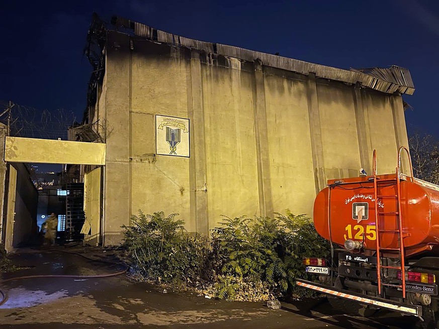 epa10246864 A fire truck stands in front of a charred building after a fire broke out at the Evin prison in Tehran, Iran, late 15 October 2022 (issued 16 October 2022). State news agency IRNA said on  ...