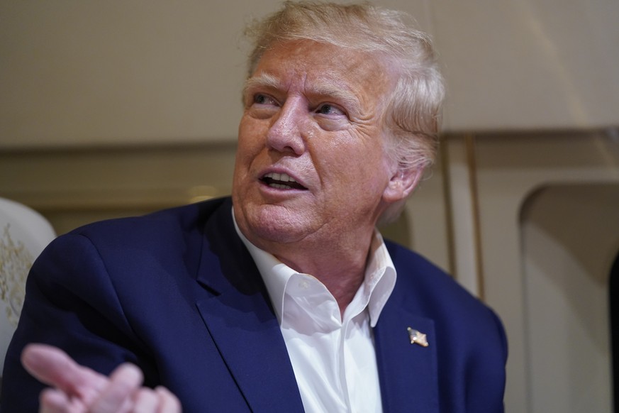 Former President Donald Trump speaks with reporters while in flight on his plane after a campaign rally at Waco Regional Airport, in Waco, Texas, Saturday, March 25, 2023, while en route to West Palm  ...