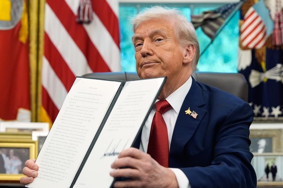 President Donald Trump holds a signed executive order regarding TikTok in the Oval Office at the White House, Thursday, Sept. 25, 2025, in Washington. (AP Photo/Alex Brandon)
Donald Trump