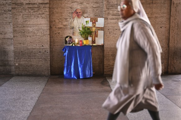 A cardboard cutout of the late Pope Francis is placed next to candles and flowers outside St. Peter&#039;s Square at the Vatican, Tuesday, April 22, 2025. (AP Photo/Francisco Seco)
APTOPIX Vatican Obi ...