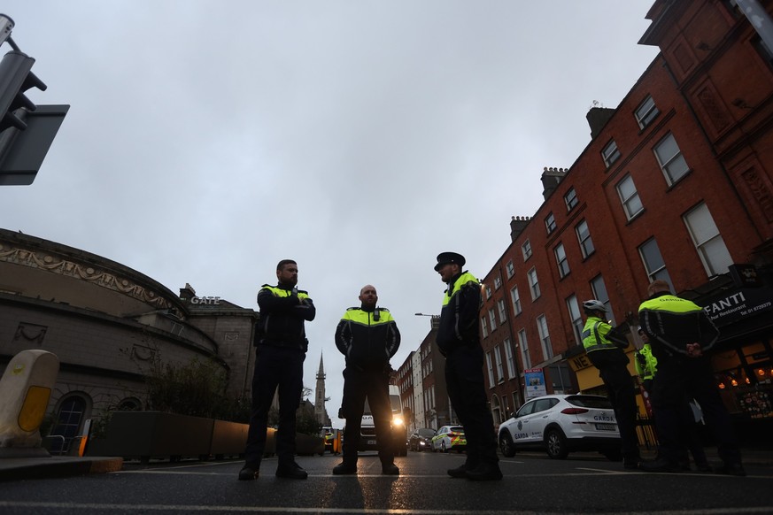epa10991095 Police officers stand near the scene following a serious incident near Parnell Street East in Dublin, Ireland, 23 November 2023. A man has been detained after allegedly five people, among  ...