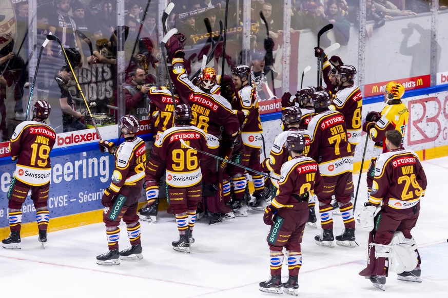 Geneve-Servette&#039;s players celebrate their victory after defeating Davos in overtime, during a National League regular season game of the Swiss Championship between Geneve-Servette HC, GSHC, and H ...
