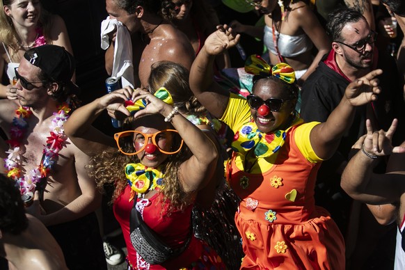 Revelers dressed as clowns dance during the Carmelitas street party on the first day of Carnival in Rio de Janeiro, Brazil, Friday, Feb. 9, 2024. (AP Photo/Bruna Prado)