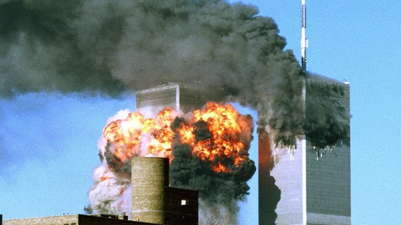 Smoke billows from the top of One World Trade Center and flames and debris explode from Two World Trade Center, Tuesday, September 11, 2001, in New York. In one of the most horrifying attacks ever aga ...