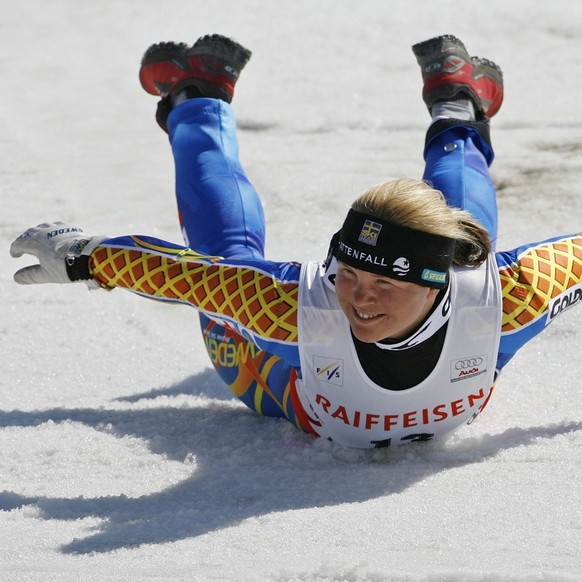 Picture 4 of 4 - Anja Paerson of Sweden runs to do her traditional victory jump and slide in the finish area after winning the women&amp;#039;s World Cup Super-G during the Alpine Ski World Cup finals ...