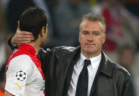 Monaco coach Didier Deschamps, right, consoles Andreas Zikos at the end of the UEFA Champions League Final between AS Monaco and FC Porto in the &#039;Arena AufSchalke&#039; in Gelsenkirchen, Germany, ...
