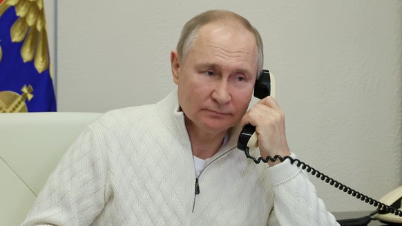 Russian President Vladimir Putin speaks on the phone to seven-year-old David Shmelev from Stavropol Krai region, a participant of the Fir Tree of Wishes charity campaign via videoconference from the N ...