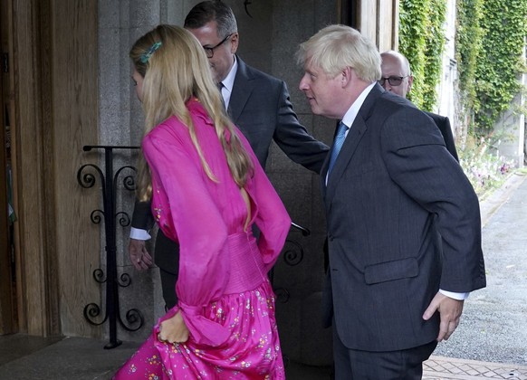 Outgoing Prime Minister Boris Johnson and his wife Carrie Johnson are greeted by the Queen's private Secretary Sir Edward Young as Johnson arrives at Balmoral for an audience with Britain's ...