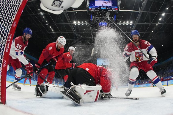 Czech Republic&#039;s Tomas Hyka (38) sprays up ice as he stops short of Switzerland goalkeeper Leonardo Genoni during a men&#039;s qualification round hockey game at the 2022 Winter Olympics, Tuesday ...