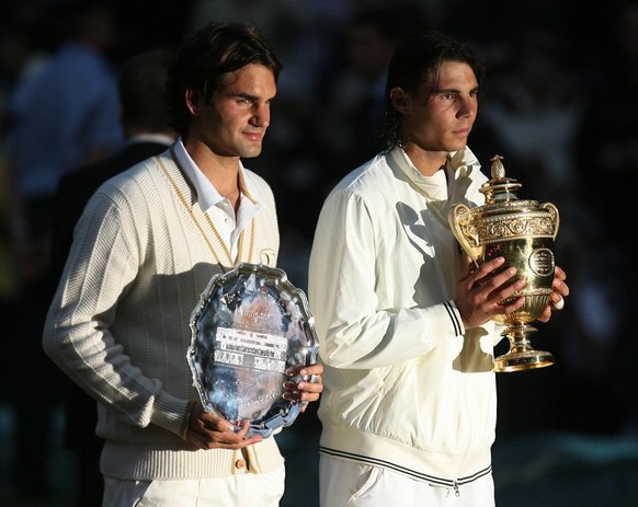 Spain&#039;s Rafael Nadal right, stands with the winners trophy next to Switzerland&#039;s Roger Federer after the men&#039;s singles final on the Centre Court at Wimbledon, Sunday, July 6, 2008. (AP  ...